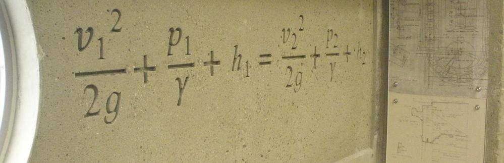 A concrete wall with equations written on it.